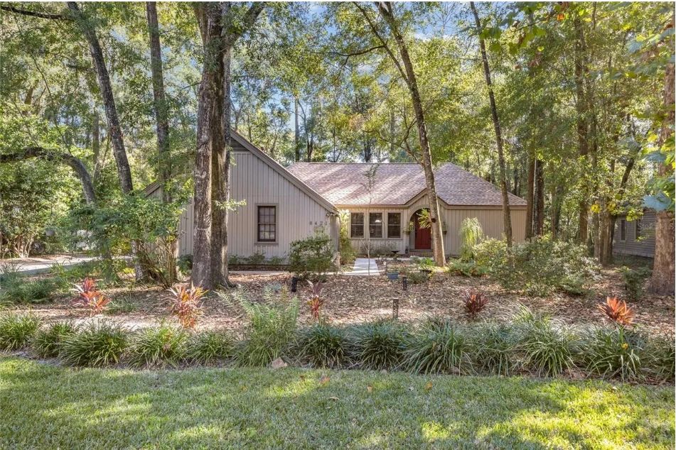 Ranch-style board-and-batten house in Gainesville with a vaulted living room and dark cherry-wood kitchen, exterior view