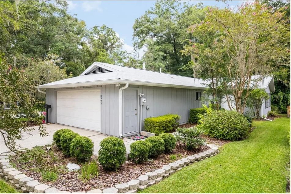Gray single-story home in Gainesville, house number 8525, side exterior view